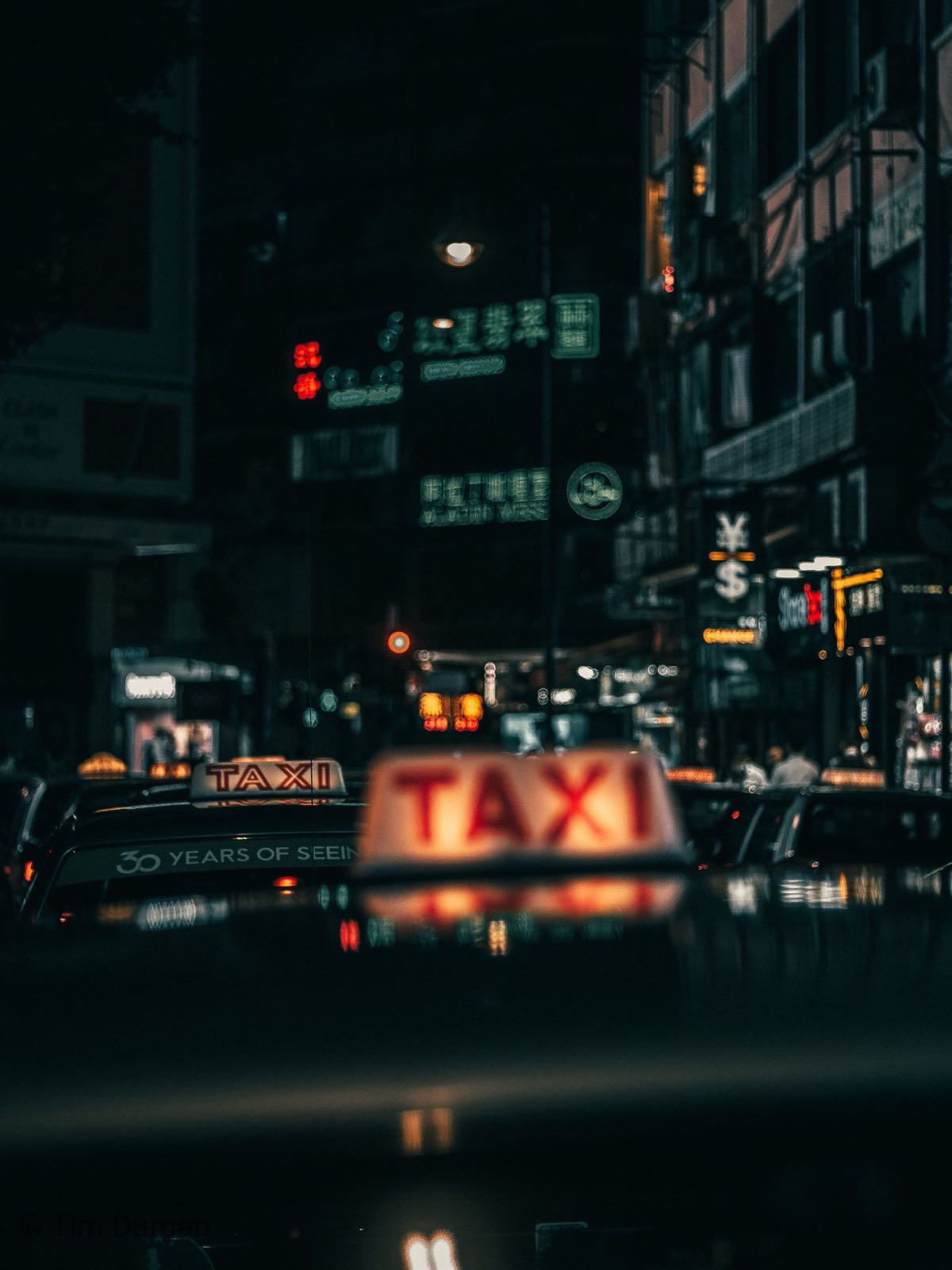 Illuminated taxi sign at night